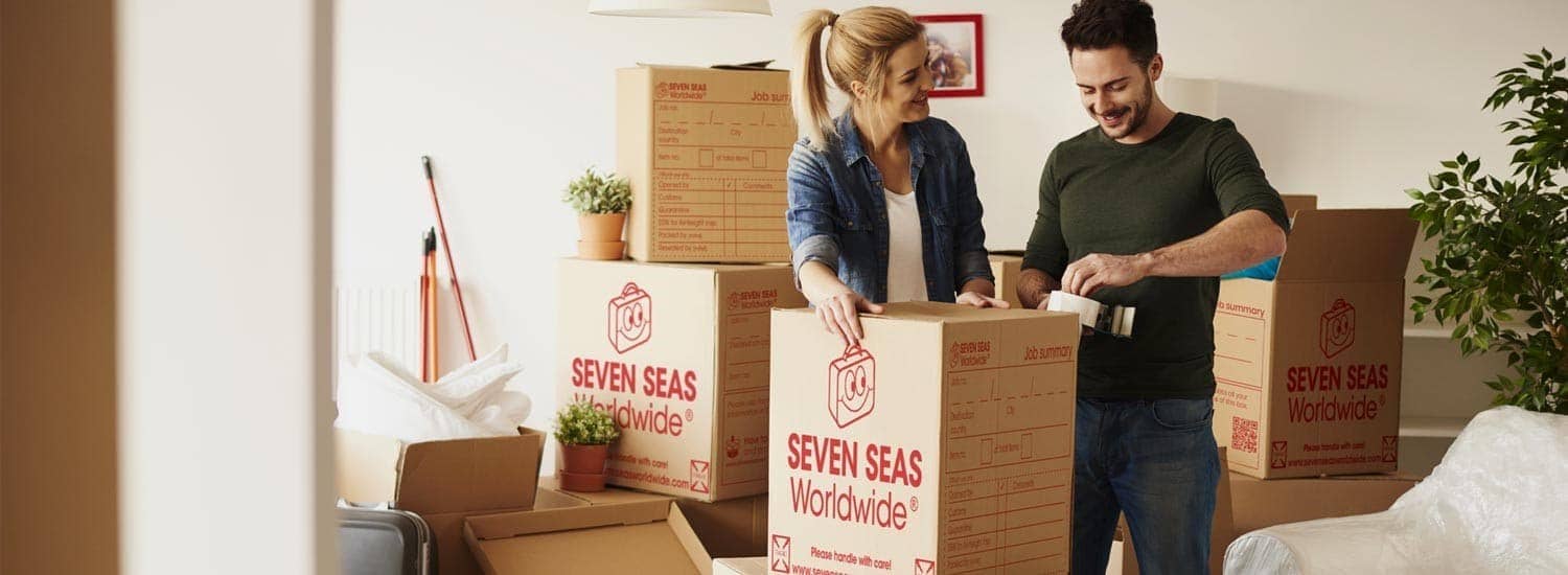 Couple preparing boxes for international shipping to New Zealand