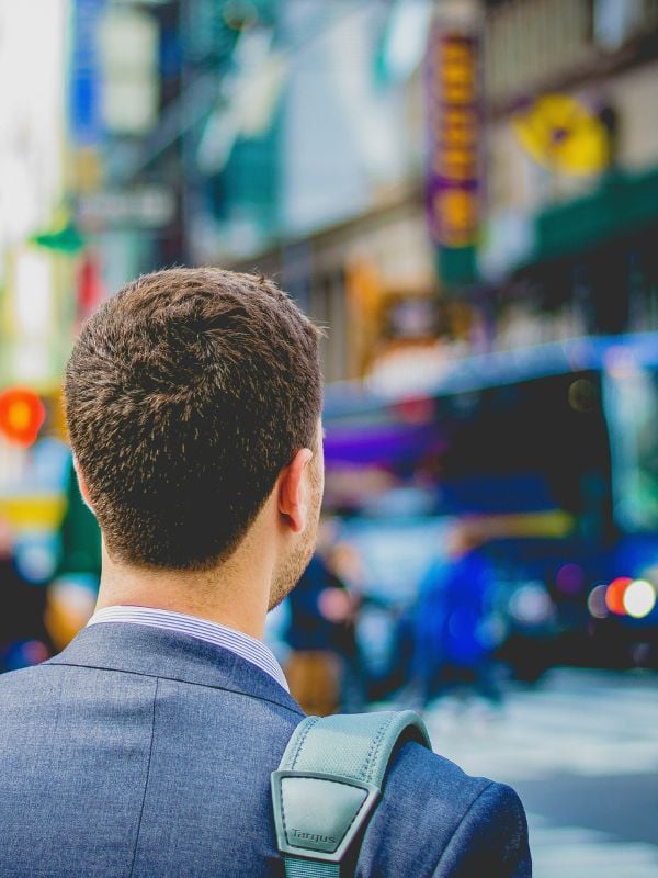 Man in a suit walking in a city