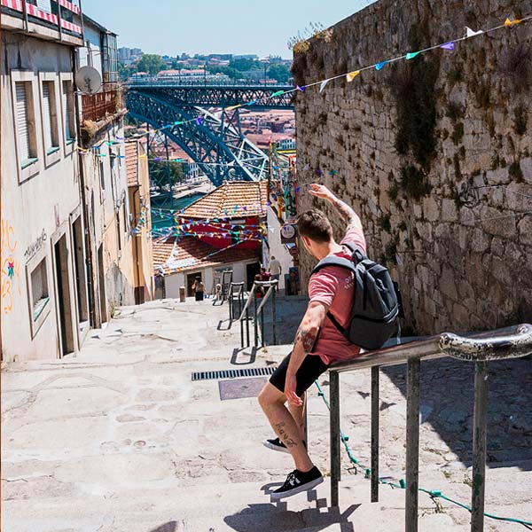 Man sliding down a stair rail in Portugal