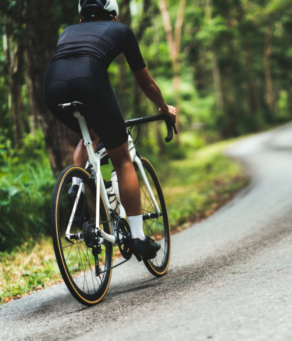 Man cycling through a forest